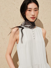 Women's white sleeveless dress with a scarf