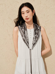 Women's white sleeveless dress with a scarf