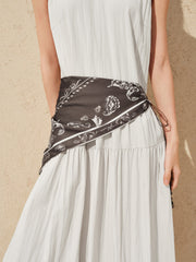 Women's white sleeveless dress with a scarf