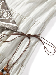 Women's white sleeveless dress with a scarf