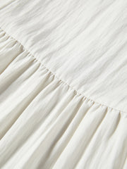 Women's white sleeveless dress with a scarf